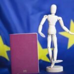 Biometric-passport-and-dummy-figurine-in-front-go-EU-flag.jpg